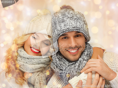 Image of happy family couple in winter clothes hugging