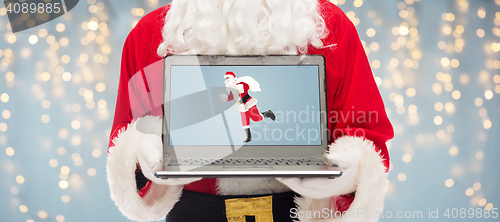 Image of close up of santa claus with laptop