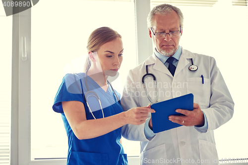 Image of senior doctor and nurse with tablet pc at hospital