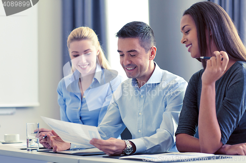 Image of business people with papers meeting in office