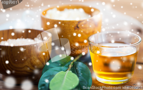 Image of close up of honey in glass with leaves on wood