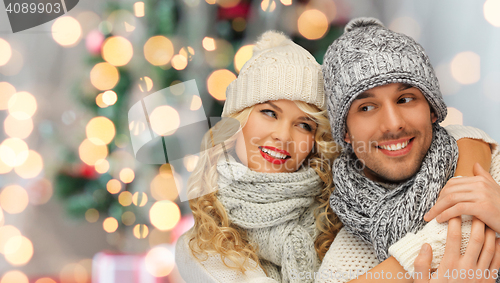 Image of happy family couple in winter clothes hugging