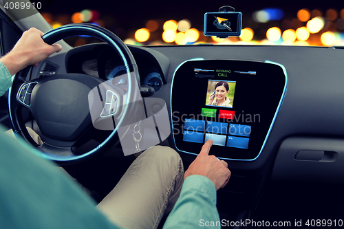 Image of close up of man driving car and receiving call