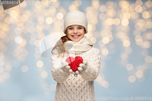 Image of girl in winter clothes with small red heart