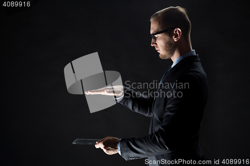 Image of close up of businessman with transparent tablet pc
