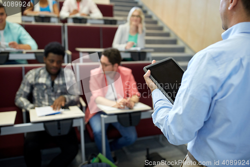 Image of teacher with tablet pc and students at lecture