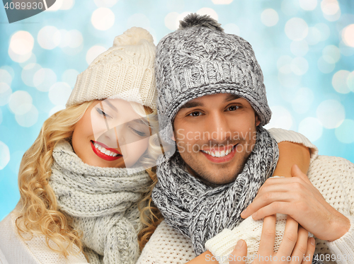 Image of happy family couple in winter clothes hugging