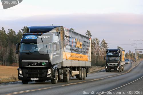 Image of Two Black Volvo Trucks Haul Mobil Delvac Oils