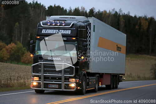 Image of Black Scania Reefer Truck on the Road at Night