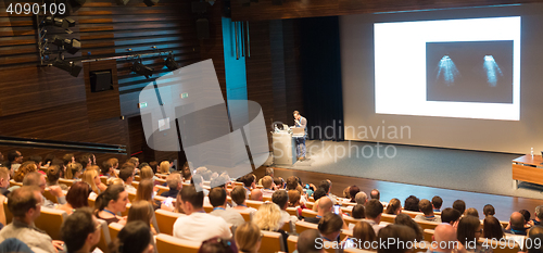 Image of Business speaker giving a talk in conference hall.