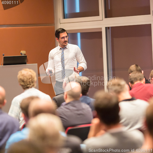 Image of Business speaker giving a talk in conference hall.