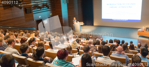 Image of Business speaker giving a talk in conference hall.