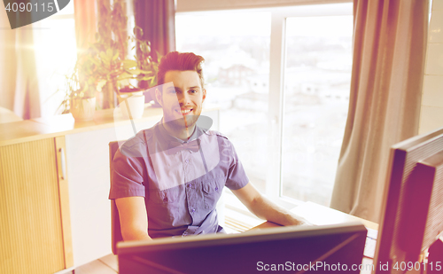 Image of happy creative male office worker with computer