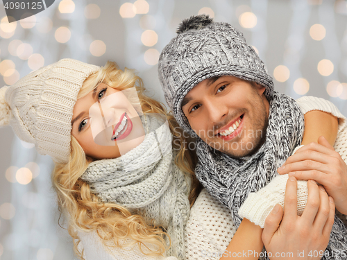 Image of happy family couple in winter clothes hugging