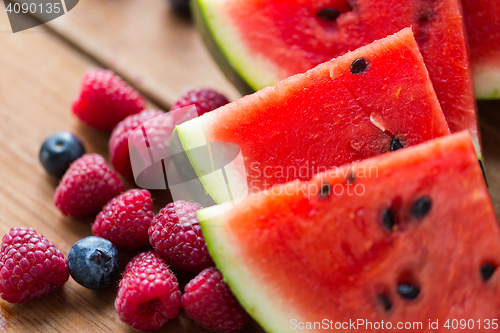 Image of close up of fruits and berries on wooden table