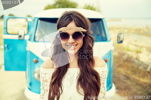 Image of smiling young hippie woman in minivan car