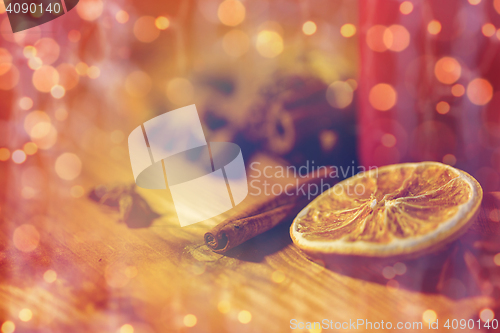 Image of cinnamon, anise and dried orange on wooden board