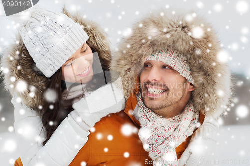 Image of happy couple having fun over winter background