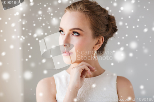 Image of beautiful woman in white with diamond earring