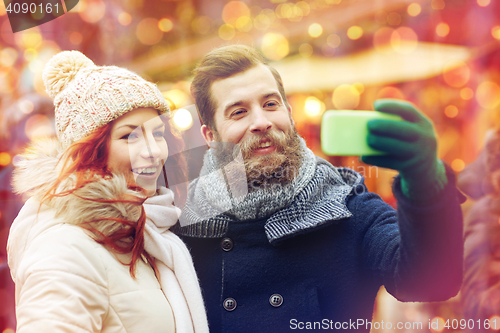 Image of couple taking selfie with smartphone in old town