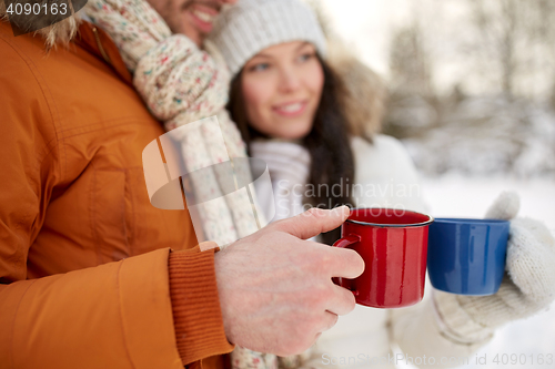 Image of close up of happy couple with tea cups in winter