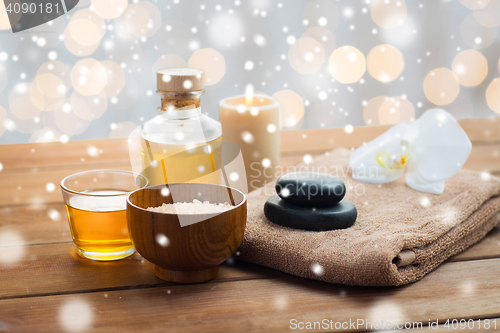 Image of sea salt, massage oil, honey and bath towel