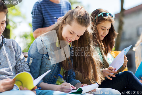 Image of group of students with notebooks at school yard