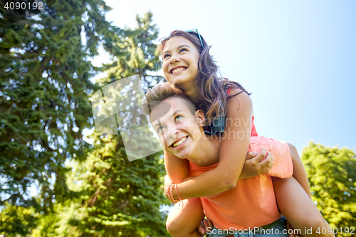 Image of happy teenage couple having fun at summer park