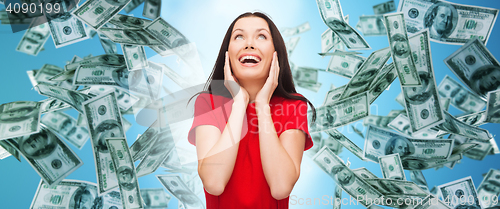 Image of amazed laughing young woman in red dress