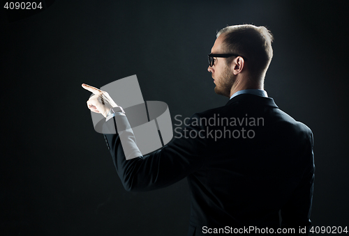 Image of businessman pointing finger to something invisible