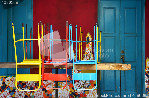 Image of Colorful chairs on a wooden table
