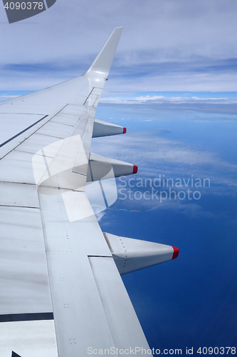 Image of Wing of an airplane on blue sky