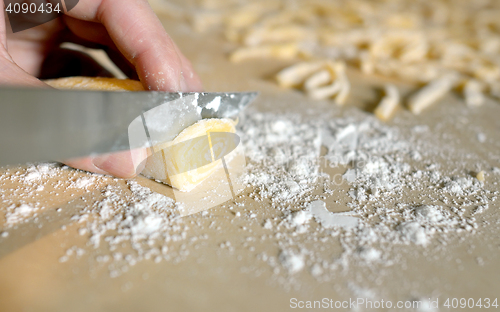 Image of Woman\'s hands knead dough