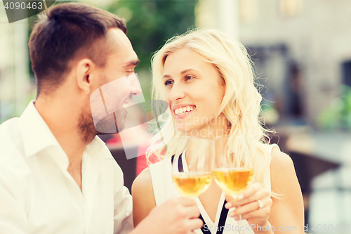 Image of happy couple clinking glasses at restaurant lounge