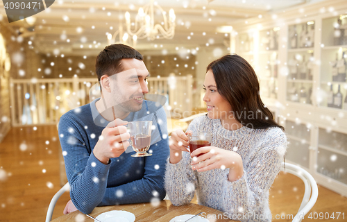 Image of happy couple drinking tea at cafe