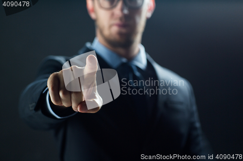 Image of close up of businessman touching virtual screen