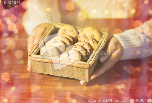 Image of close up of woman with christmas oat cookies