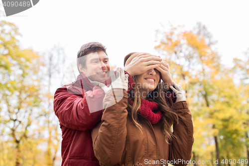 Image of happy young couple having fun in autumn park