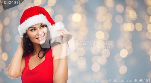 Image of beautiful sexy woman in santa hat and red dress