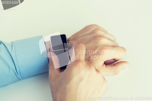 Image of close up of male hands setting smart watch