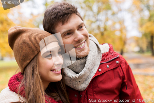 Image of happy young couple walking in autumn park