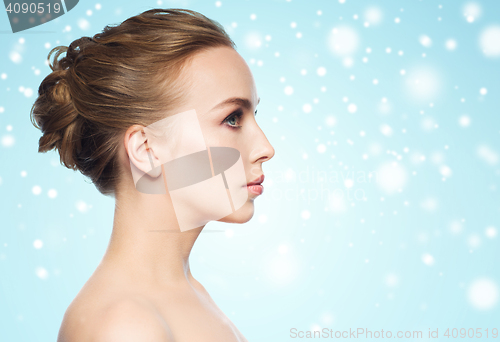 Image of beautiful young woman face over snow