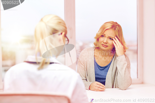 Image of smiling doctor and woman meeting at hospital