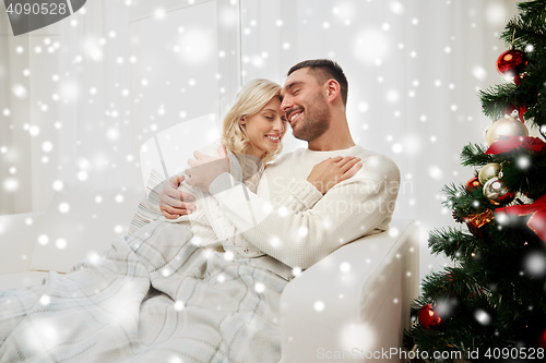 Image of happy couple at home with christmas tree