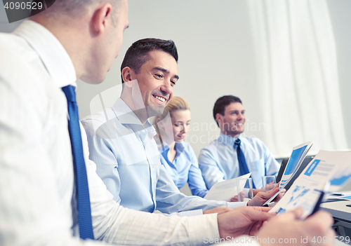 Image of smiling business people meeting in office