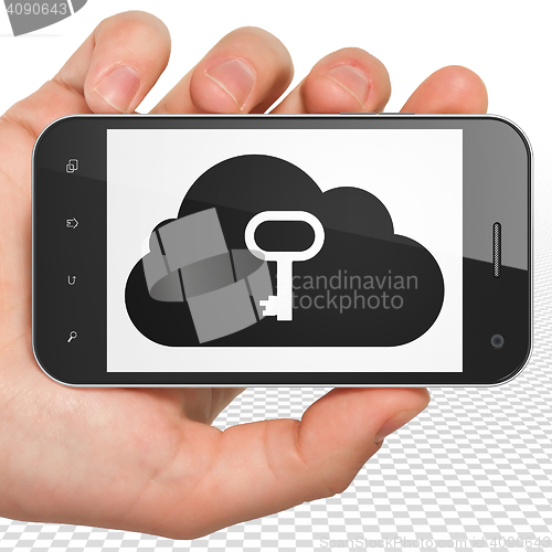 Image of Cloud networking concept: Hand Holding Smartphone with Cloud With Key on display