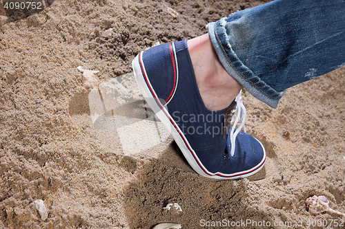 Image of Man\'s Legs And Footprint On The Sand