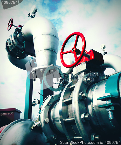 Image of Industrial zone, Steel pipelines and valves against blue sky