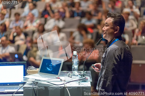 Image of Public speaker giving talk at Business Event.