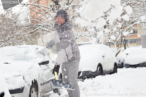 Image of Man shoveling snow in winter.
